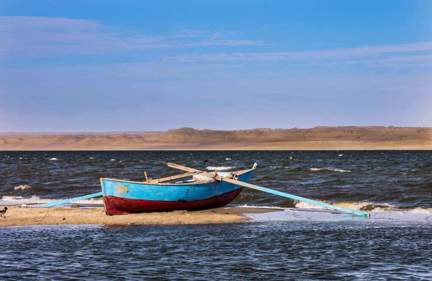 a wonderful shot of a boat on one of the shores of lake qarun in fayoum