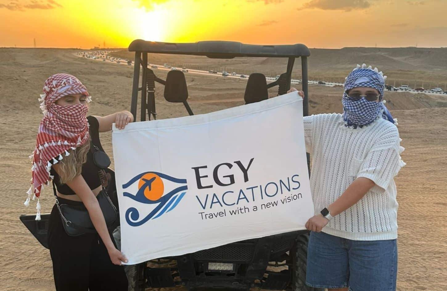 a great shot of the couple with our flag from the pyramids area