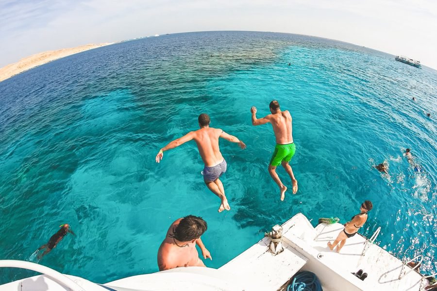 A wonderful shot of two people jumping into the water on one of the beaches of Ras Mohammed