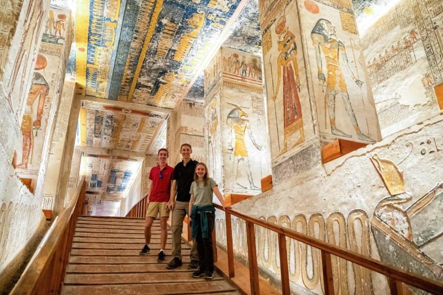 Visitors exploring the brilliantly preserved ancient murals in a tomb at the Valley of the Kings, Luxor