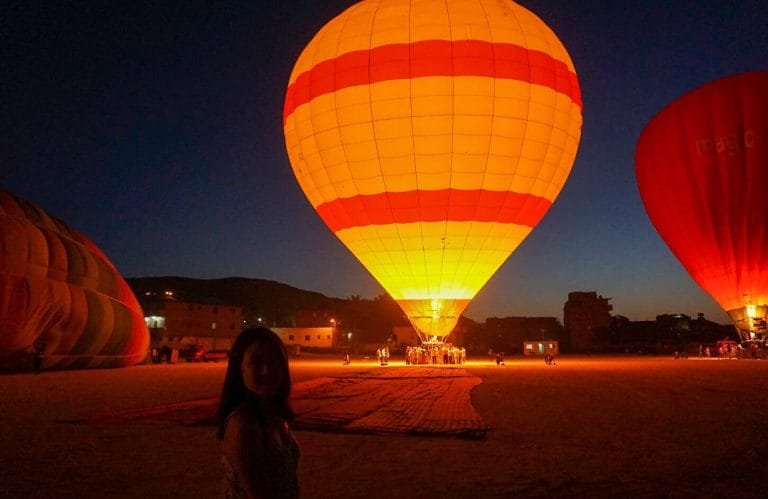 A picture of a tourist while preparing a hot air balloon