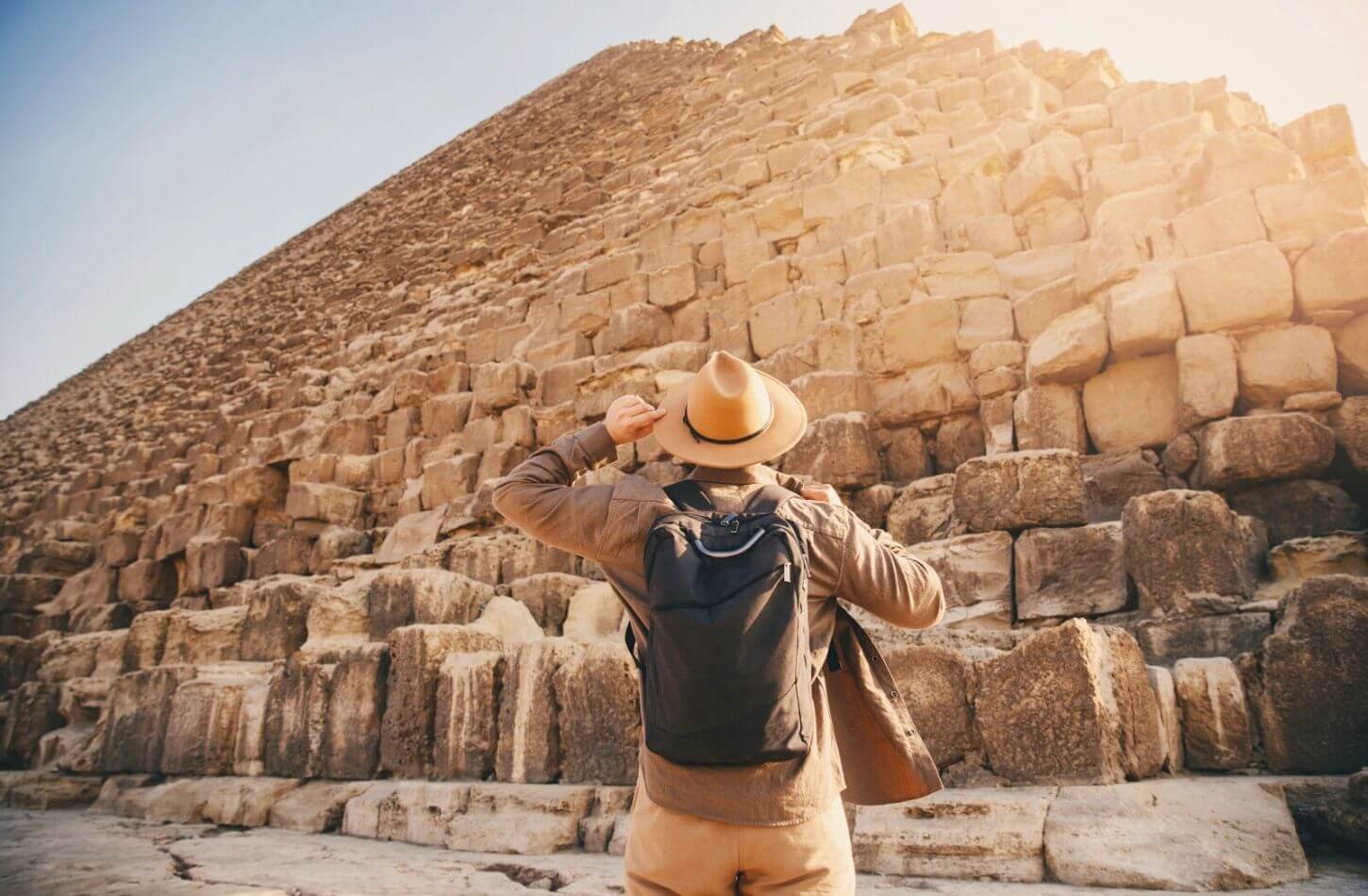 explorer looking up at great pyramid giza