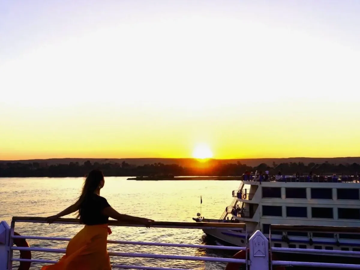 woman watching sunset on nile river cruise deck