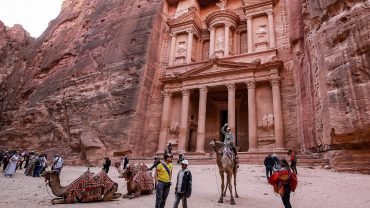 A wonderful photo of a tourist in front of the Petra Temple