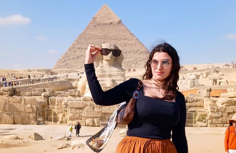 amazing shot girl takes a photo with the sphinx
