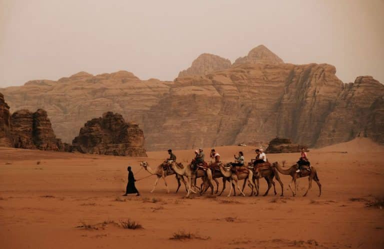 a special shot of a group of tourists in wadi rum