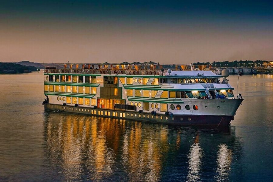 The multi-deck acamar Nile Cruise Ship sailing majestically down the river at sunset in Egypt