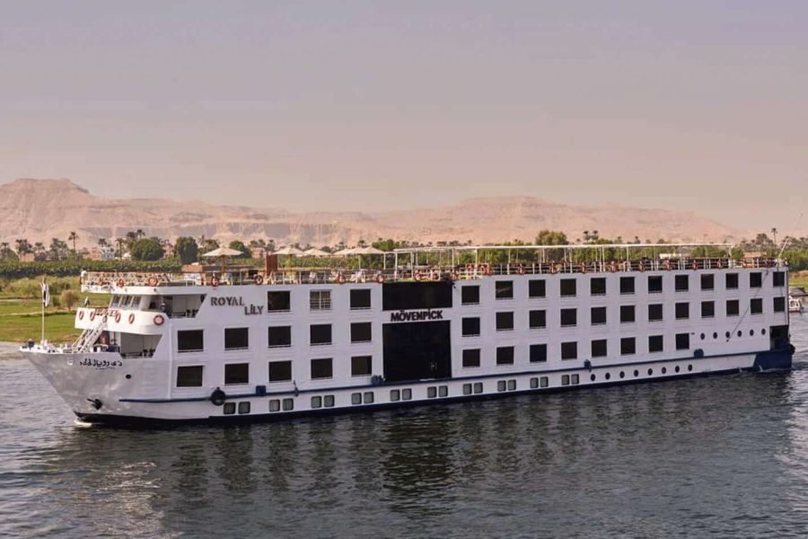 Broadside view of the large Movenpick Royal Lily vessel cruising the waters of the Nile River