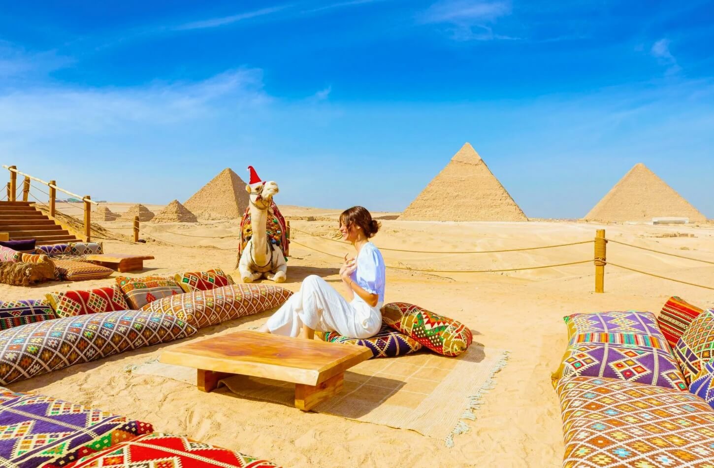 A Tourist woman celebrates Christmas in front of the pyramids of Giza in Egypt.
