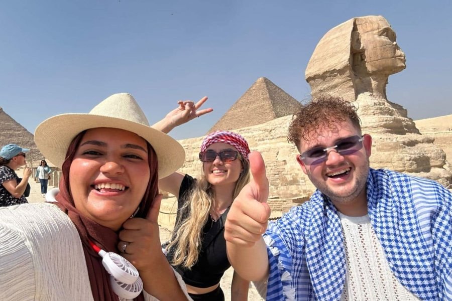 a wonderful shot of a couple with our friendly guide in front of the sphinx
