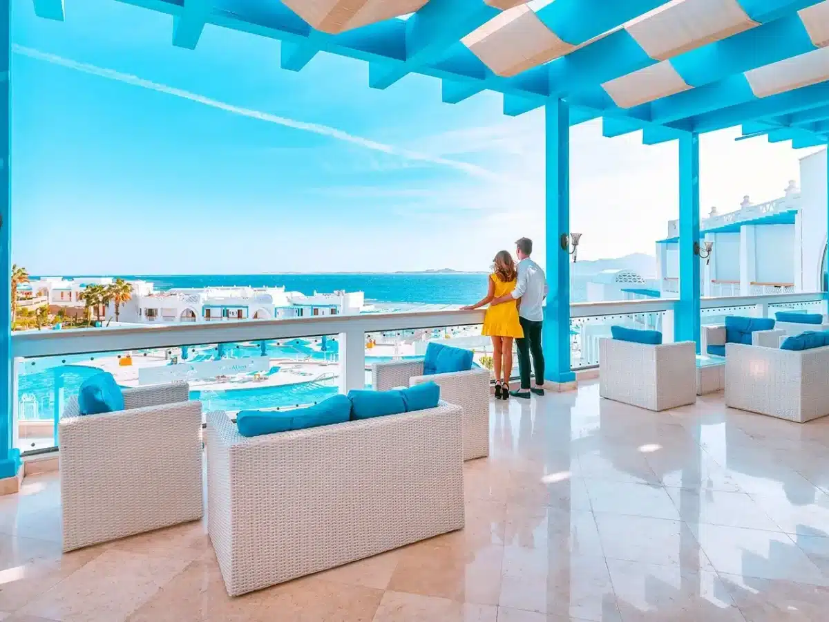 Couple enjoying the view from a luxury Red Sea hotel balcony with blue architecture and ocean views.
