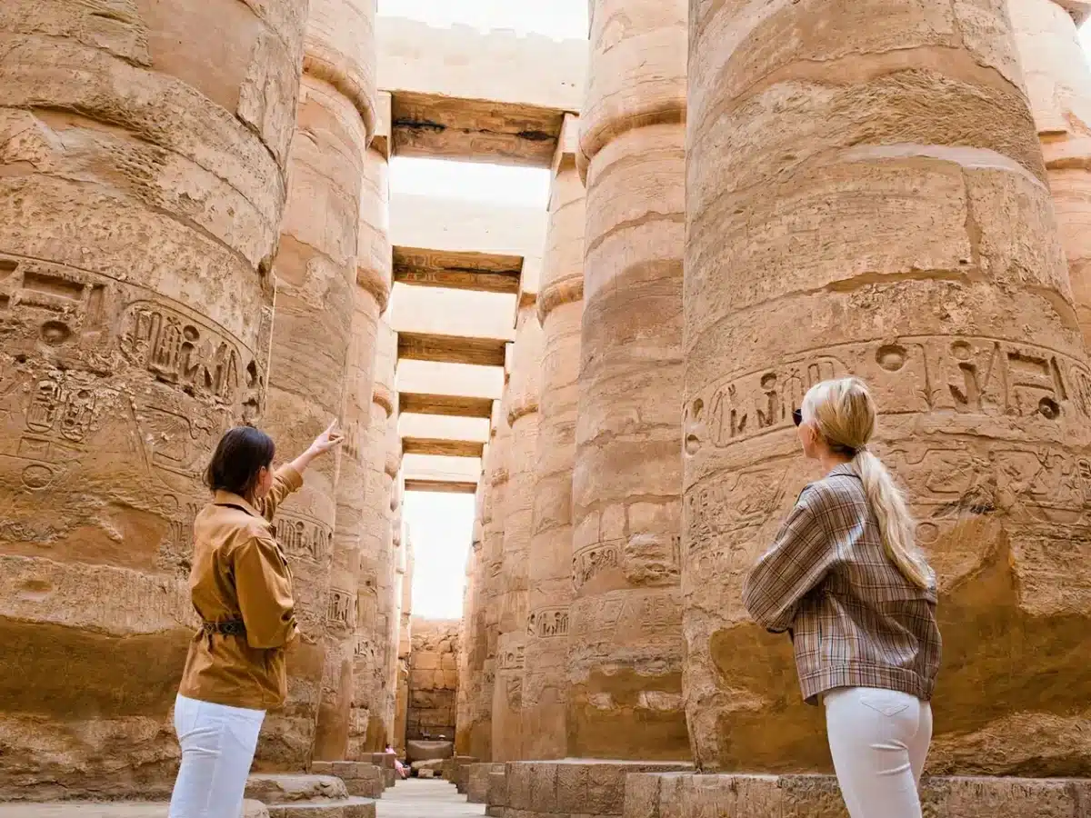 Do You Need a Tour Guide in Egypt? Here’s Why It’s Worth It 1 Expert tour guide in Egypt pointing out hieroglyphics at the Karnak Temple complex in Luxor.