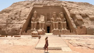 A stunning photo of a girl in front of the Abu Simbel temple - Solo Travel to Egypt