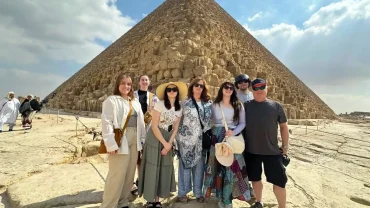 Group of tourists standing in front of the Great Pyramid of Giza during a guided tour in Egypt - Egypt Travel Advice