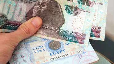 Egypt tourist visa with Egyptian pound banknotes showing the cost of an Egypt visa and local currency.