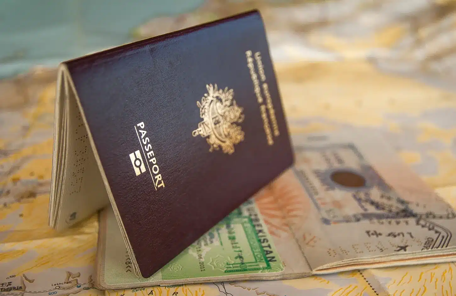 Passport with visa and immigration stamps alongside official passport stamps used during international travel. - Egypt Visa Guide