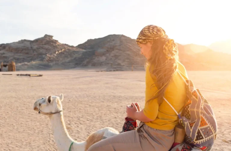 A stunning shot of a girl on a camel riding adventure in the Sharm El Sheikh and Hurghada desert