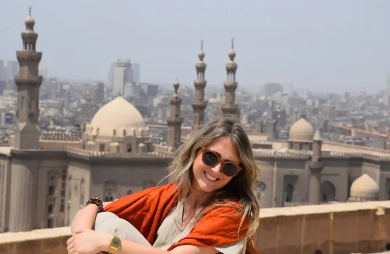 A wonderful picture of a girl sitting in front of the Al Rifai and Sultan Hassan mosques